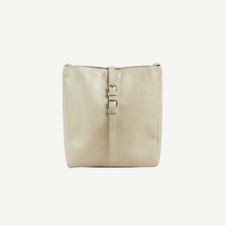 Bolso Buckle Soft Tote Beige Arena en textura tipo piel con hebilla frontal. Ligero, espacioso y elegante, ideal para looks casuales y planes de día o fin de semana.