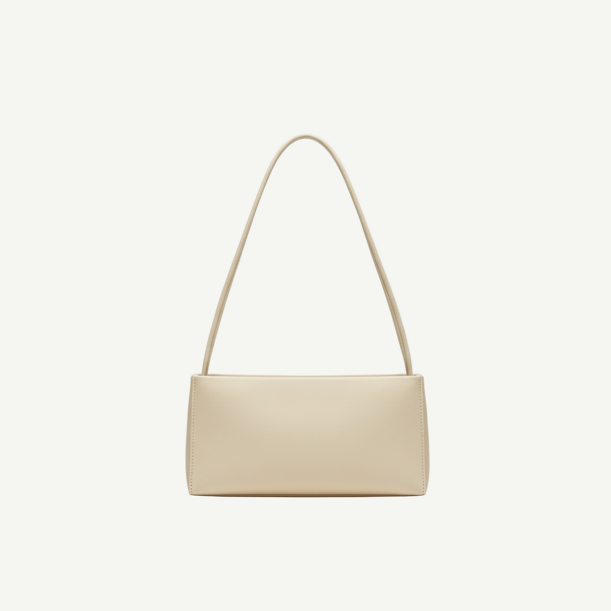 Bolso Rectangular Minimal Ivory en material vegano premium, silueta alargada y asa larga. Ligero, elegante y versátil, ideal para looks diarios o de noche.
