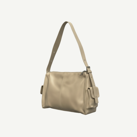 Bolso Soft Shoulder Taupe en material vegano premium, con asa ajustable y bolsillos laterales. Ligero, versátil y moderno, ideal para looks urbanos y minimalistas.