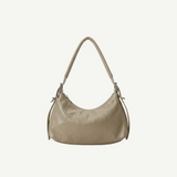Bolso Crescent Taupe en PU vegano premium con textura arrugada y silueta curva. Ligero, flexible y moderno, ideal para uso diario y looks casual.